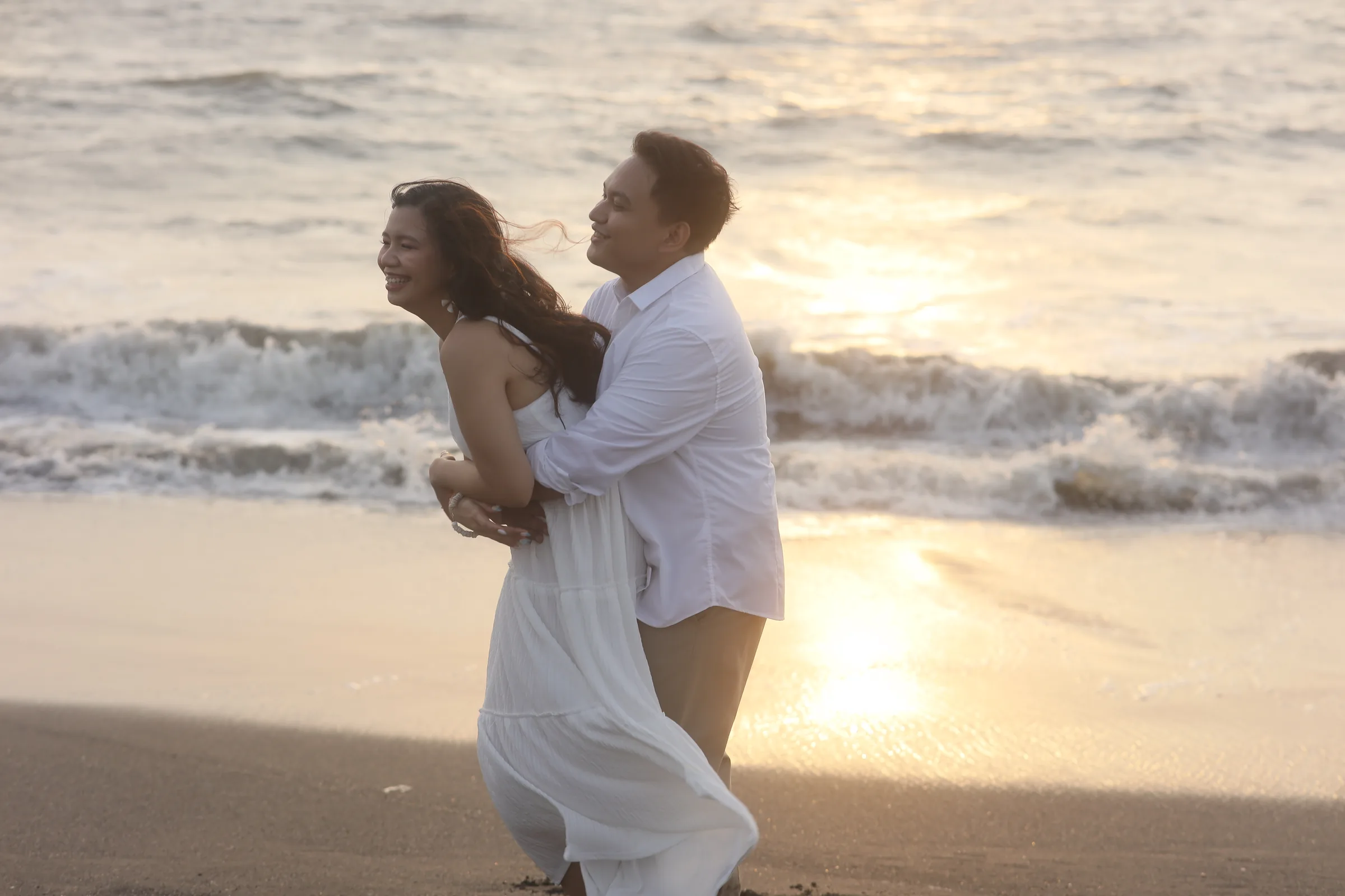 Deymi and Mark together beside the sea at sunset